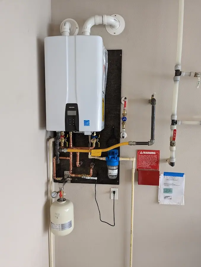 Professional plumber installing copper piping in a Somerset home